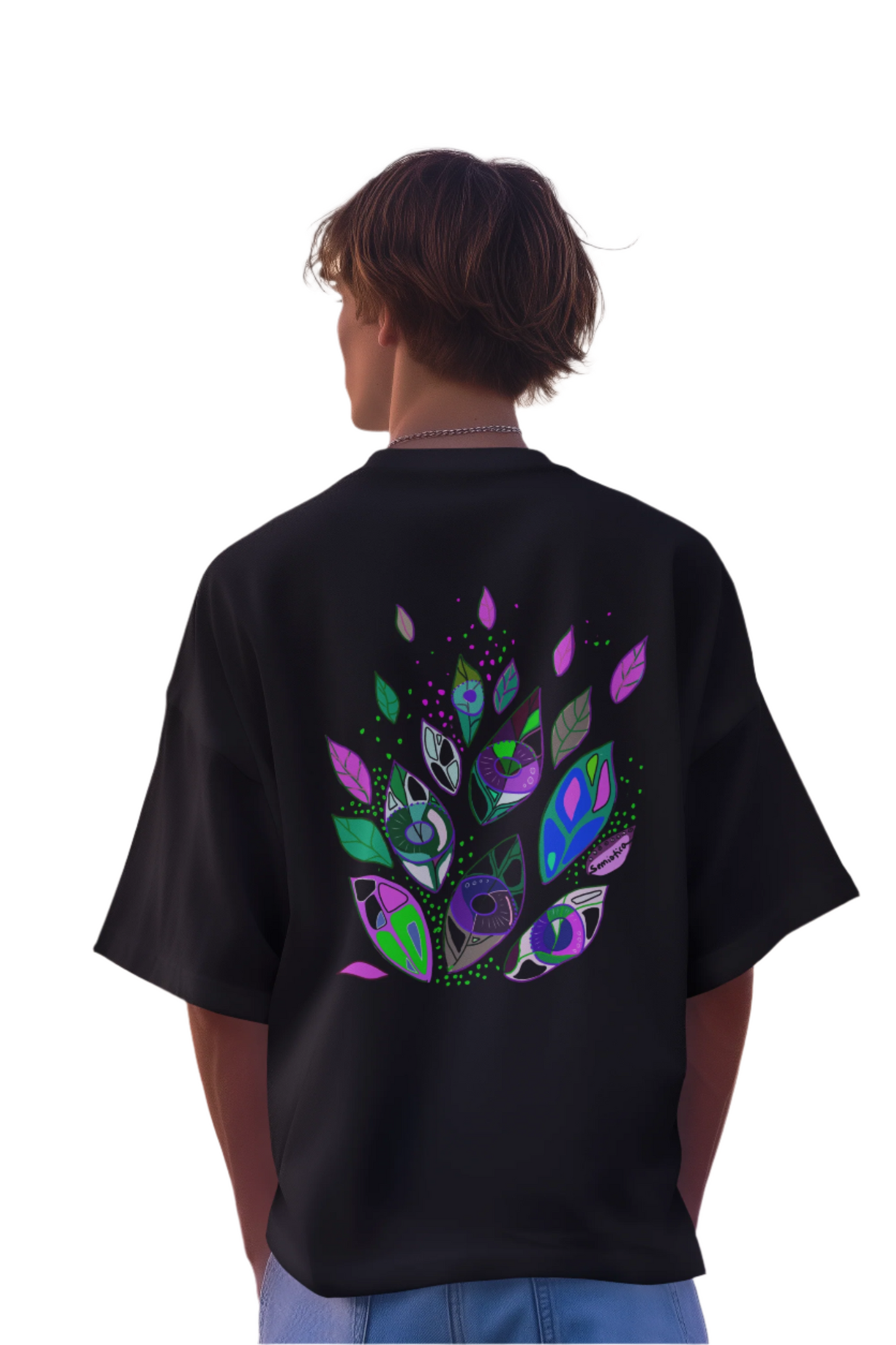 Man wearing the Seeds of Seeing black t-shirt, showcasing the colorful abstract print on the back.