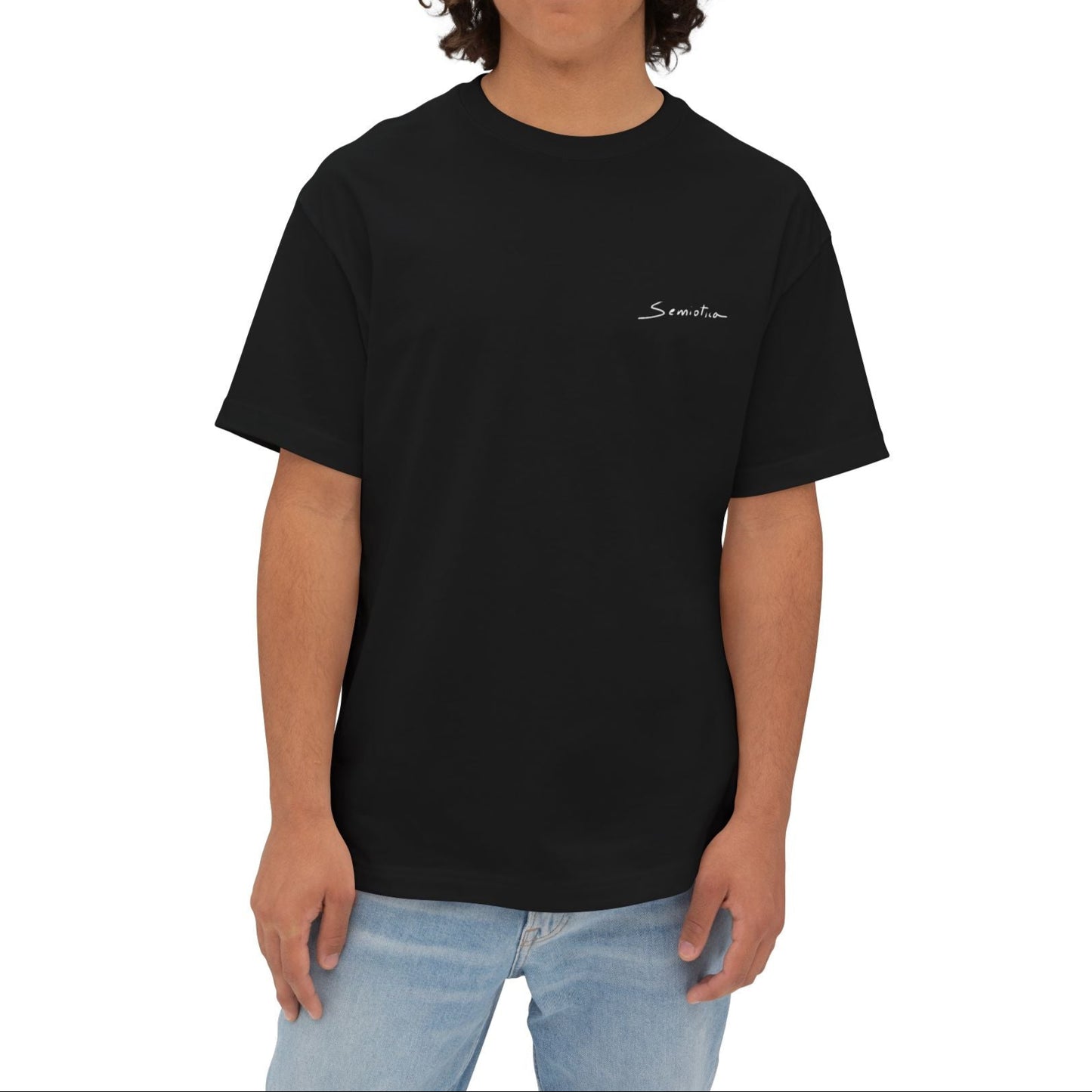 Model wearing black Semiotica t-shirt with front logo, styled with relaxed fit jeans.