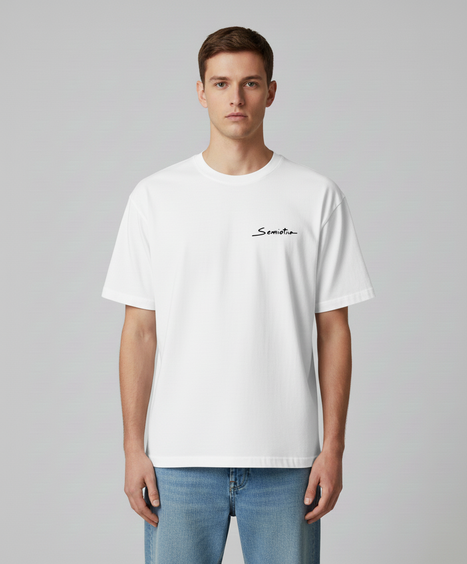 Man wearing a white t-shirt with black logo printed from Semiotica on a gray background