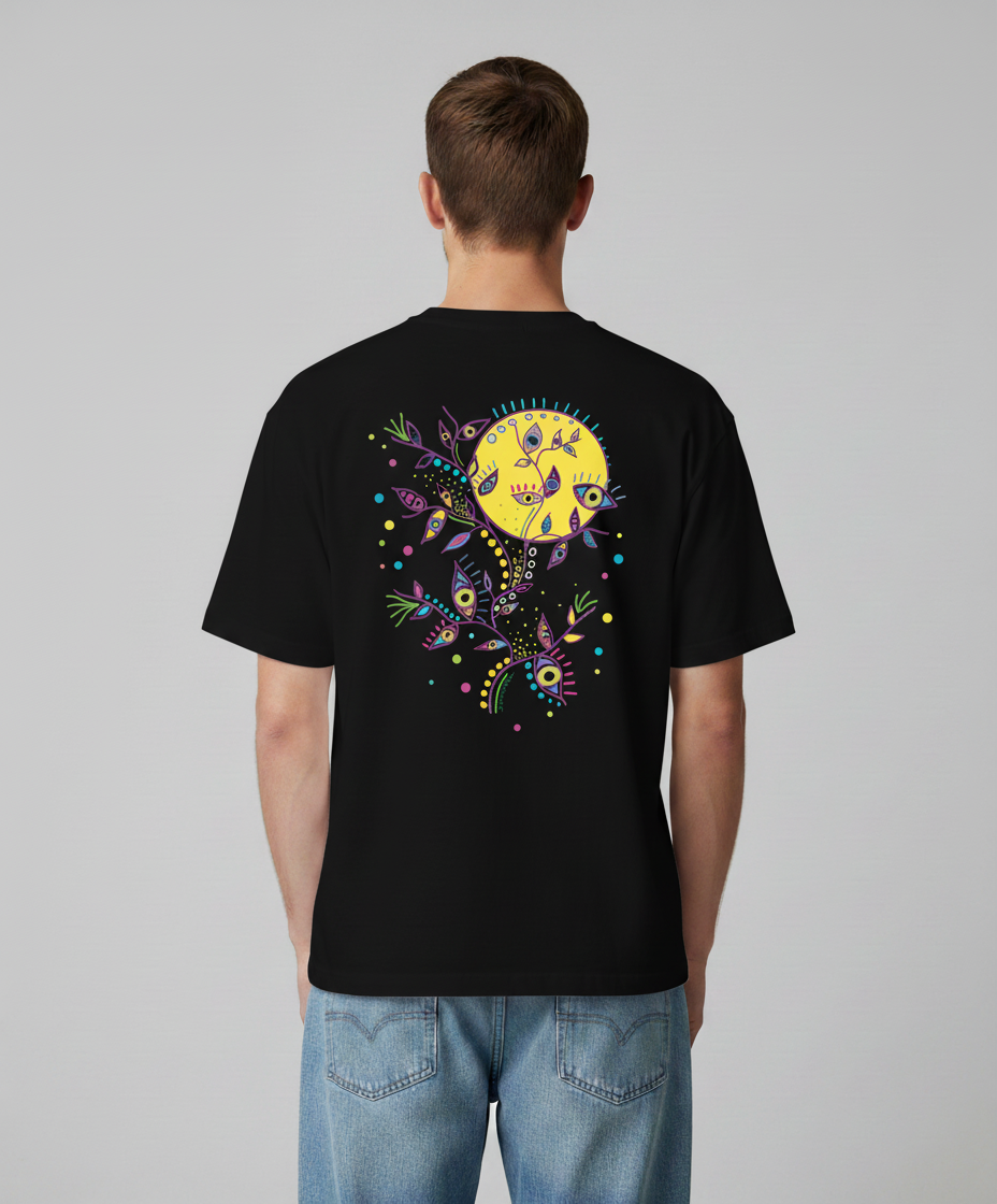 Man wearing a black t-shirt from Semiotica with a colorful design on the back against a gray background