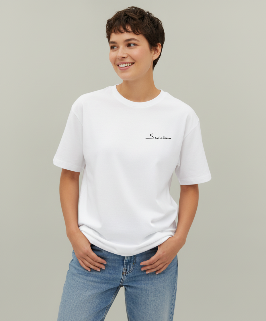 Woman wearing a white t-shirt from Semiotica with a logo on a plain background