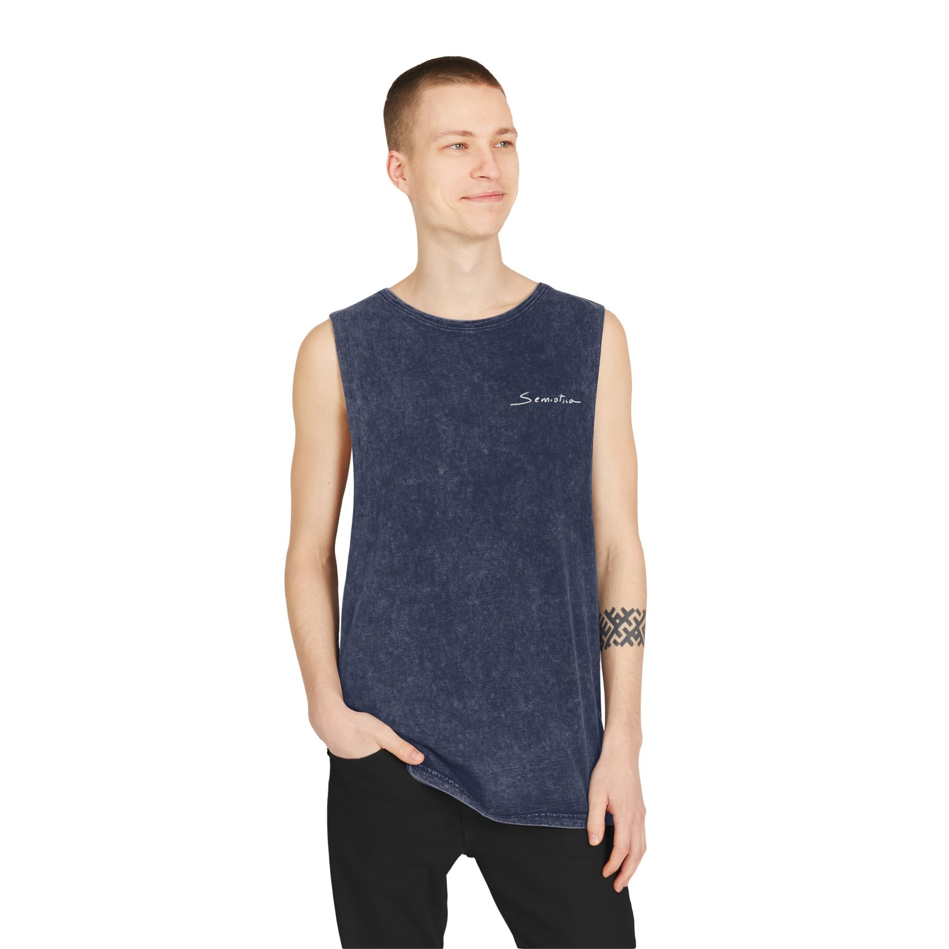 Model wearing the Semiotica Heartbeat Spiral unisex tank top in stonewash navy, front logo visible