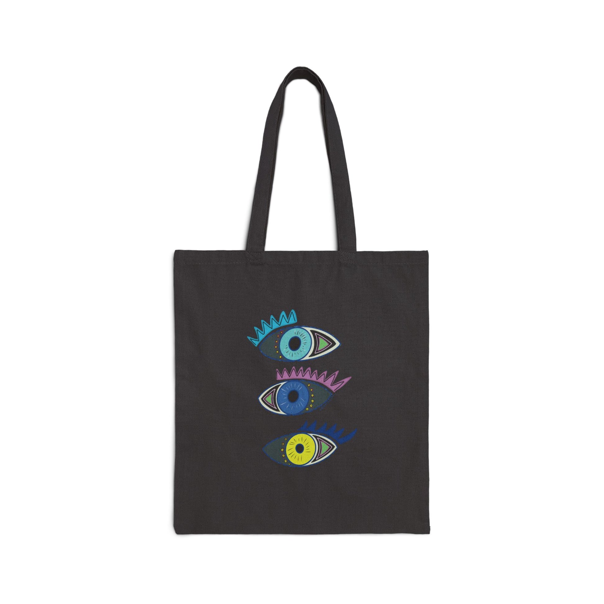 Black tote bag from Semiotica with colorful eye designs on a white background