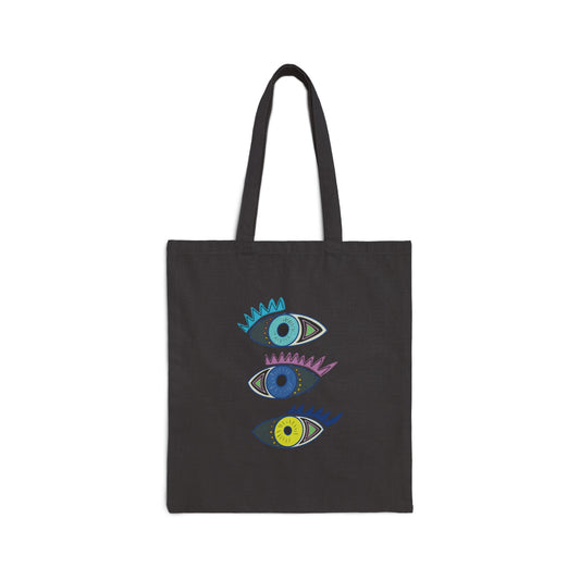 Black tote bag from Semiotica with colorful eye designs on a white background
