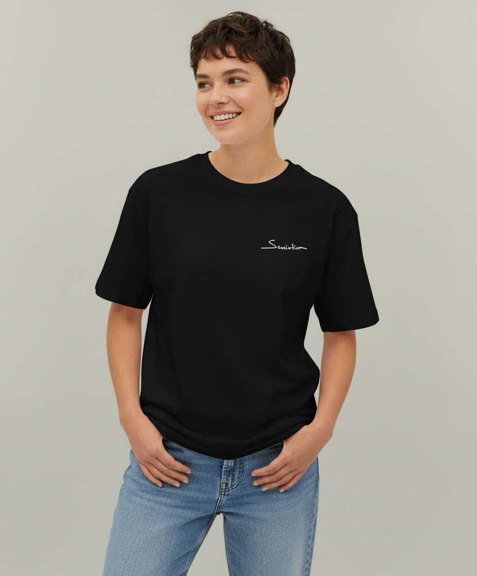 Woman wearing a black t-shirt with a logo on a plain background