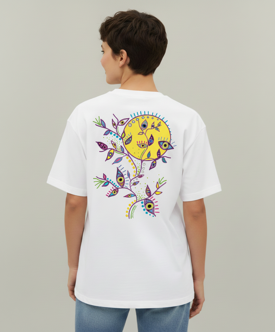 Woman wearing a white t-shirt from Semiotica with a colorful design on the back against a plain background