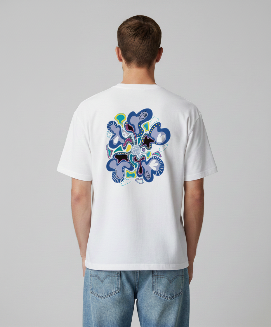 Man wearing a white t-shirt from Semiotica with a colorful abstract design on the back against a gray background