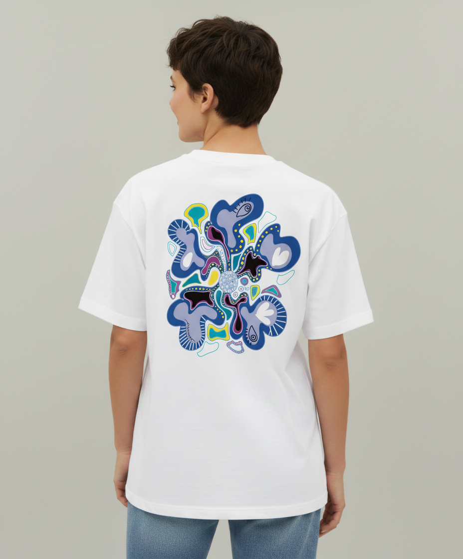 Woman wearing a white t-shirt from Semiotica with a colorful abstract design on the back against a plain background