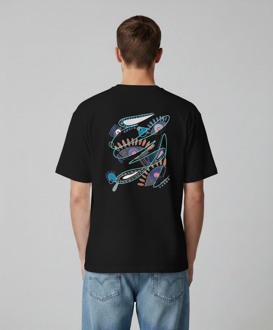 Man wearing a black t-shirt from Semiotica with a colorful snake design on the back against a gray background