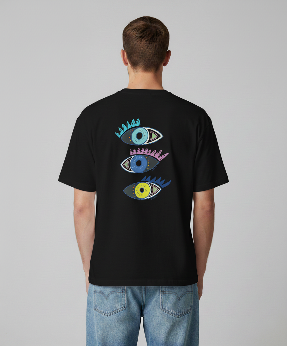 Man wearing a black t-shirt from Semiotica with colorful eye designs on the back against a gray background